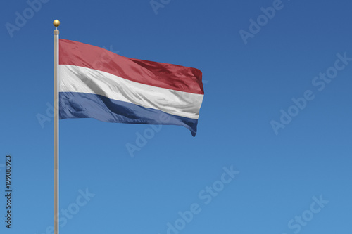 Netherlands Flag in front of a clear blue sky