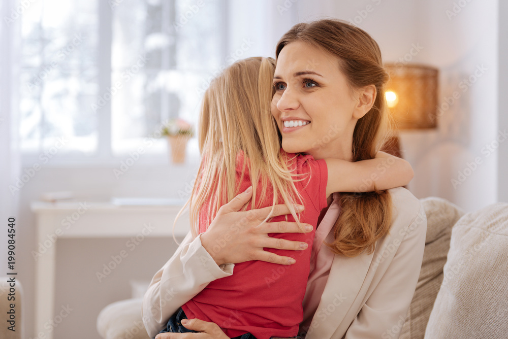 My beloved daughter. Happy delighted nice mother smiling and hugging her daughter while expressing her feelings to her My beloved daughter. Happy delighted nice mother smiling and hugging her daughter while expressing her feelings to her