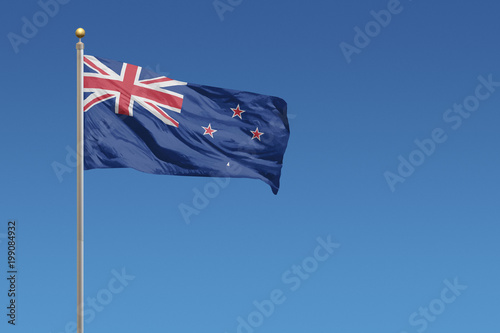 Photography New Zealand Flag of in front of a clear blue sky
