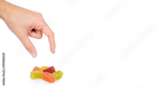 Various color of fruity gummy jelly candies in hand isolated on white background. copy space, template photo