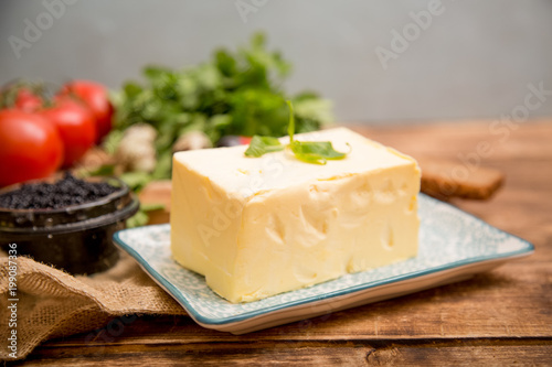 Natural food and ingredients, breakfast with butter, bread and black caviar on wooden background