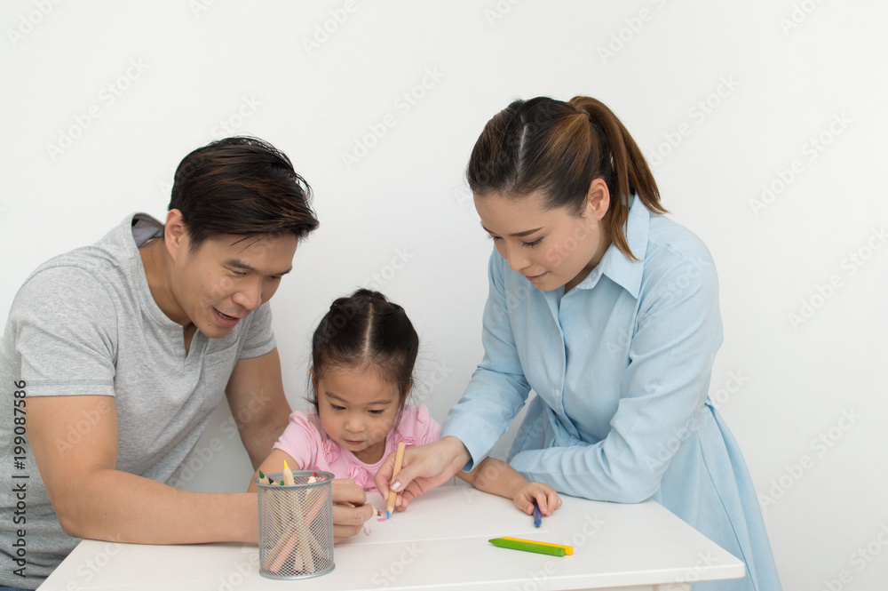 Concept Family. Familys are drawing activities in the home. Family is doing happy activities. Parents are teaching drawing children. Concept Family. Familys are drawing activities in the home. Family is doing happy activities. Parents are teaching drawing children.