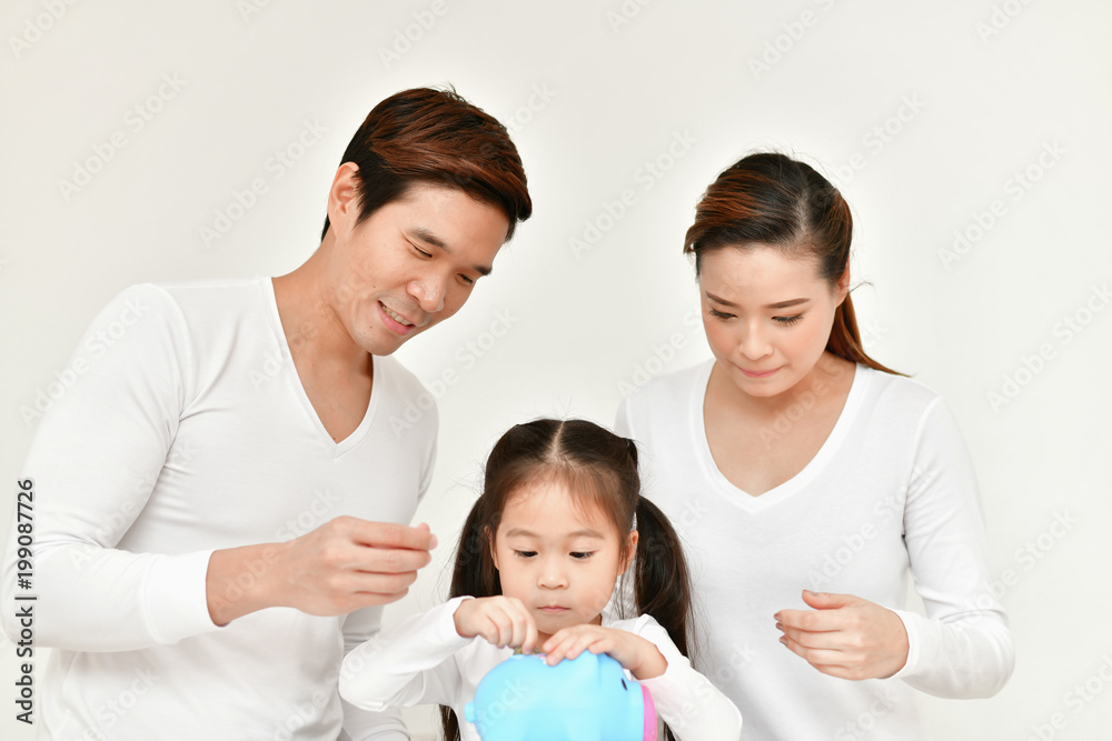 Family Concept. Parents are teaching children to save money. Family is doing happy activities at home. Parents are playing happily. Family Concept. Parents are teaching children to save money. Family is doing happy activities at home. Parents are playing happily.
