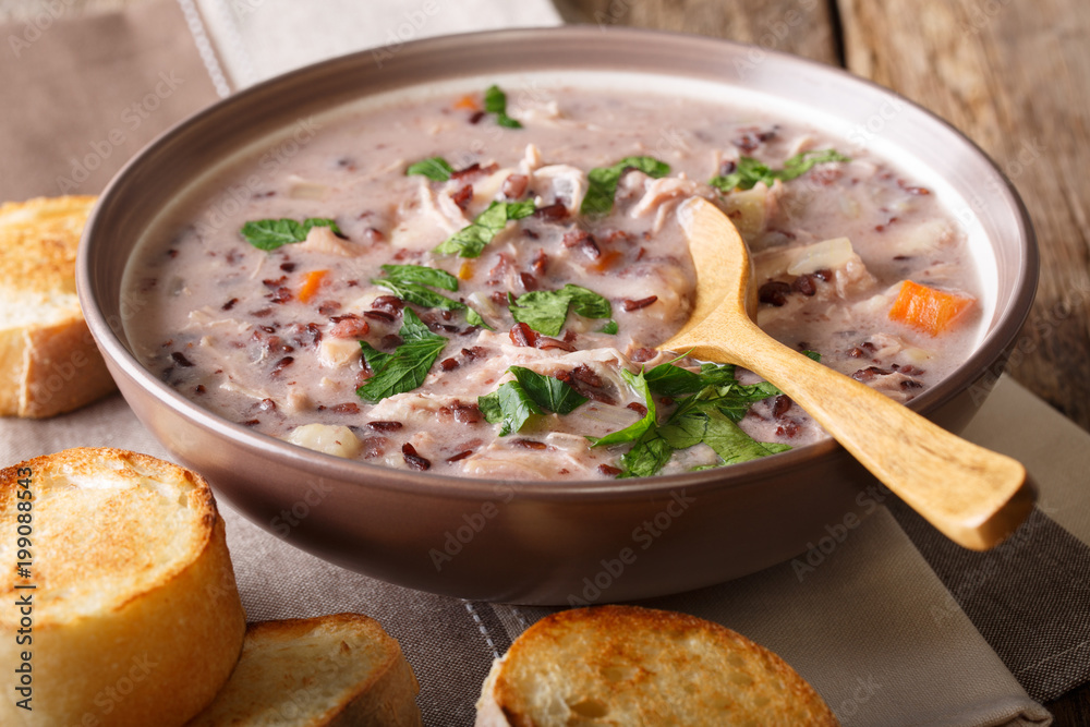 Homemade creamy soup of wild rice with chicken and vegetables close-up. horizontal Homemade creamy soup of wild rice with chicken and vegetables close-up. horizontal