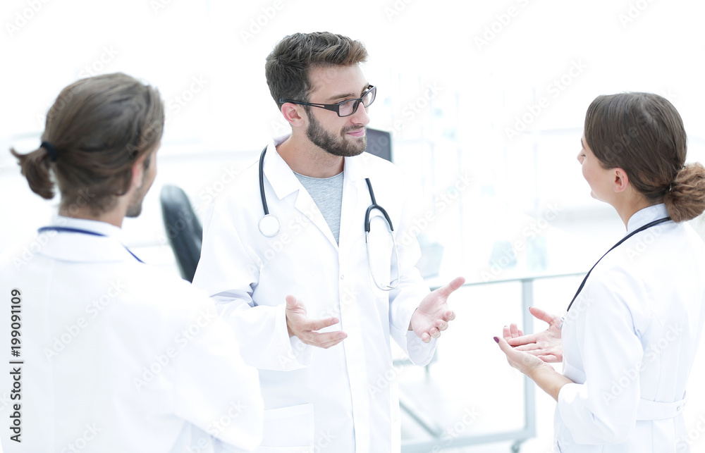 Medical staff discuss in a modern hospital room Medical staff discuss in a modern hospital room