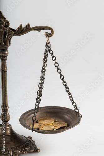 coins on the white background. gold on the scales.
