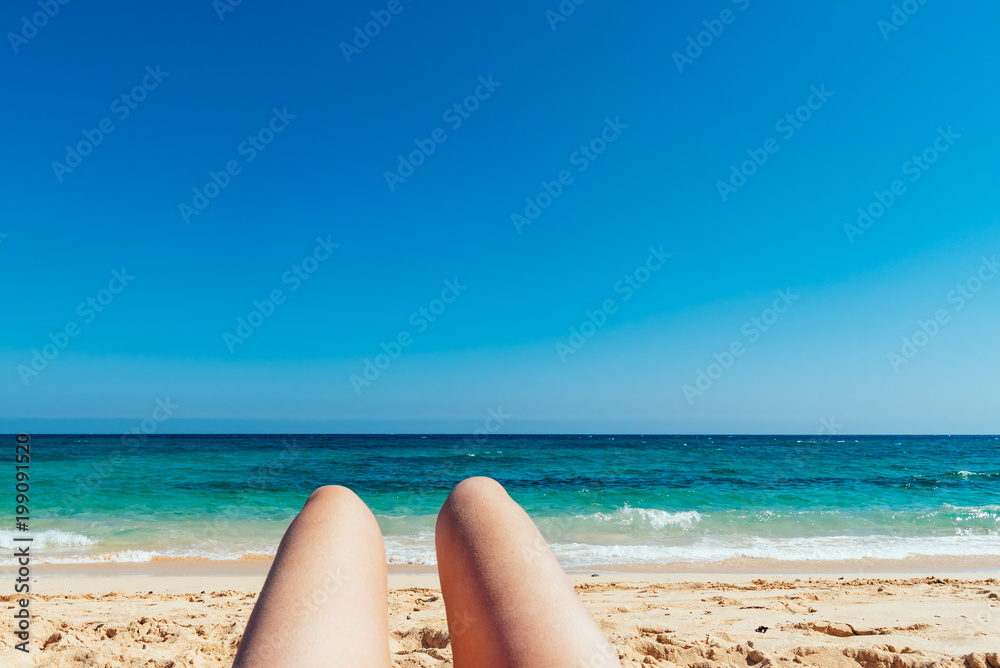 Mature woman legs sunbathing on the beach Mature woman legs sunbathing on the beach