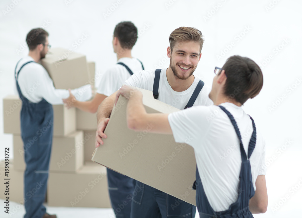 Portrait of movers holding box smiling isolated on white backgro Portrait of movers holding box smiling isolated on white backgro