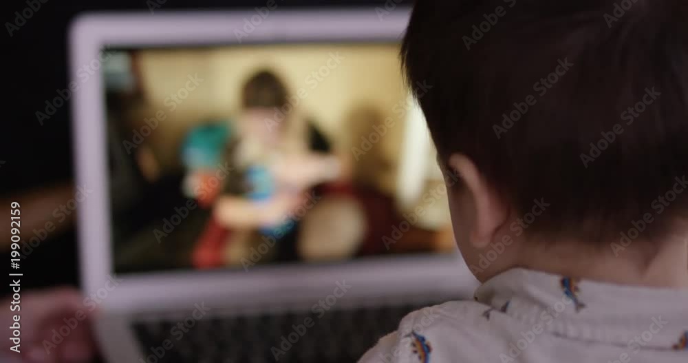 Toddler watching content on laptop computer Toddler watching content on laptop computer