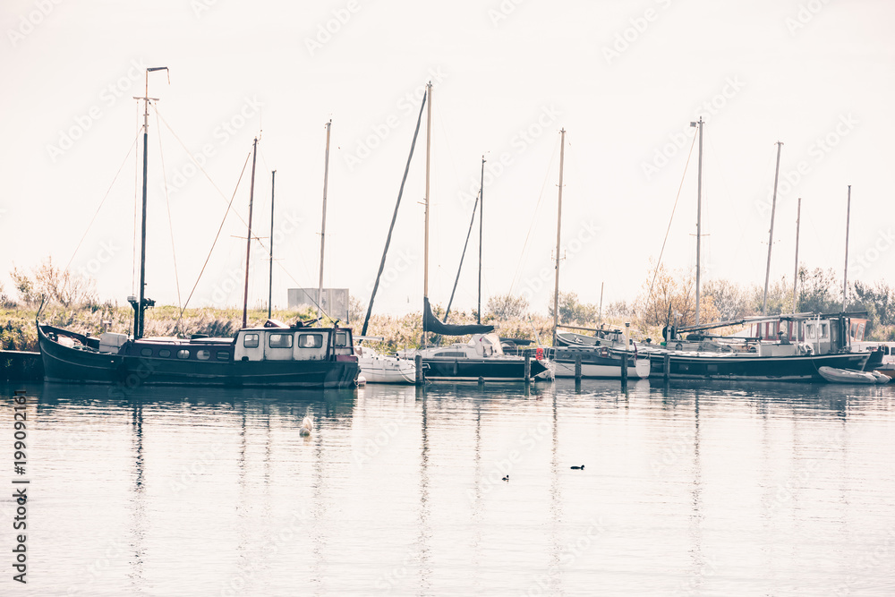 Harbor of a dutch village with sailing yachts