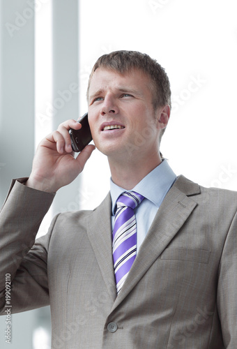 Businessman at the window talking on the phone