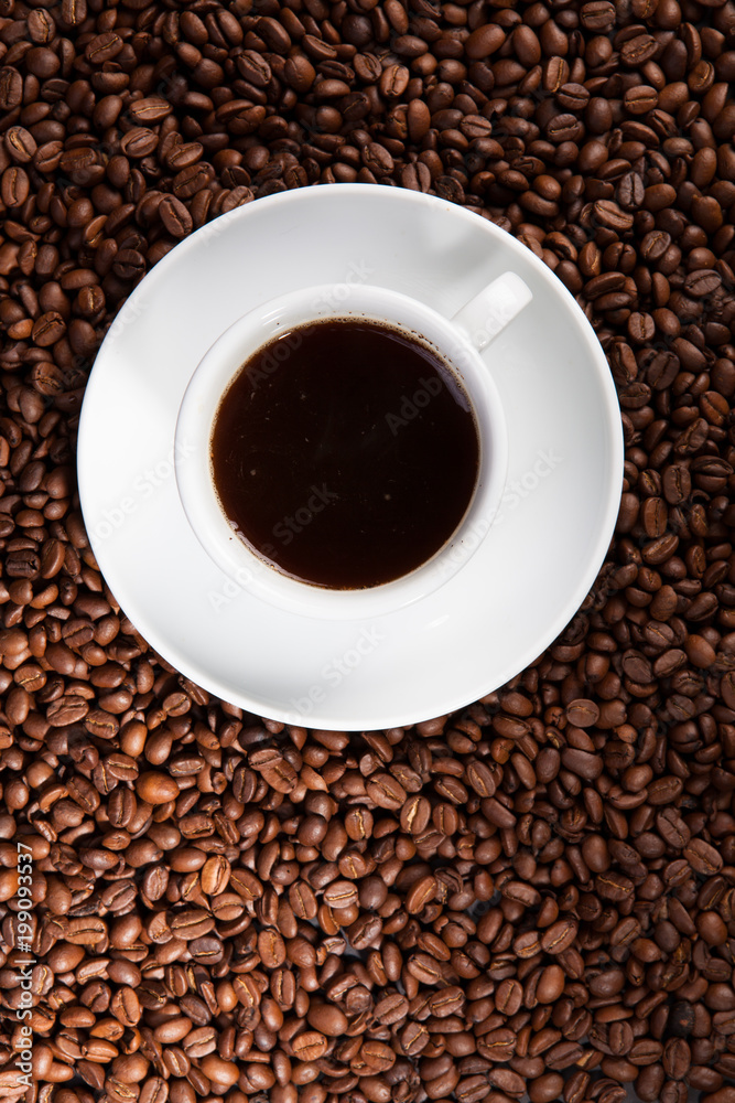 white cup of coffee at coffee beans backgrounds white cup of coffee at coffee beans backgrounds