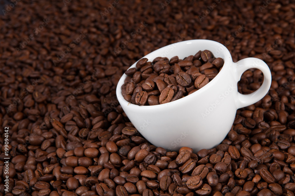 white cup of coffee at coffee beans backgrounds white cup of coffee at coffee beans backgrounds