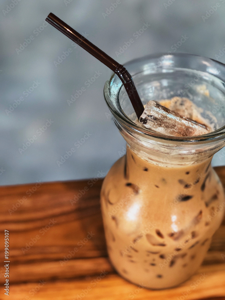ice coffee in glass on the wooden table , vintage and low light in the  cafe .Sweet and fresh.copy space