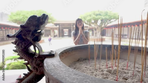 the incense burner and Asian faithful female photo