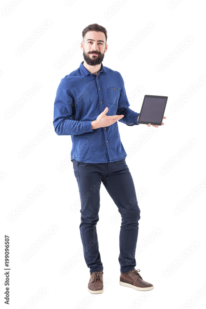 Happy smiling smart casual business man holding and showing blank touch pad screen looking at camera. Full body isolated on white background. Happy smiling smart casual business man holding and showing blank touch pad screen looking at camera. Full body isolated on white background.