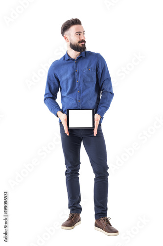 Confident successful smiling bearded business man showing tablet with blank empty white screen. Full body isolated on white background. 