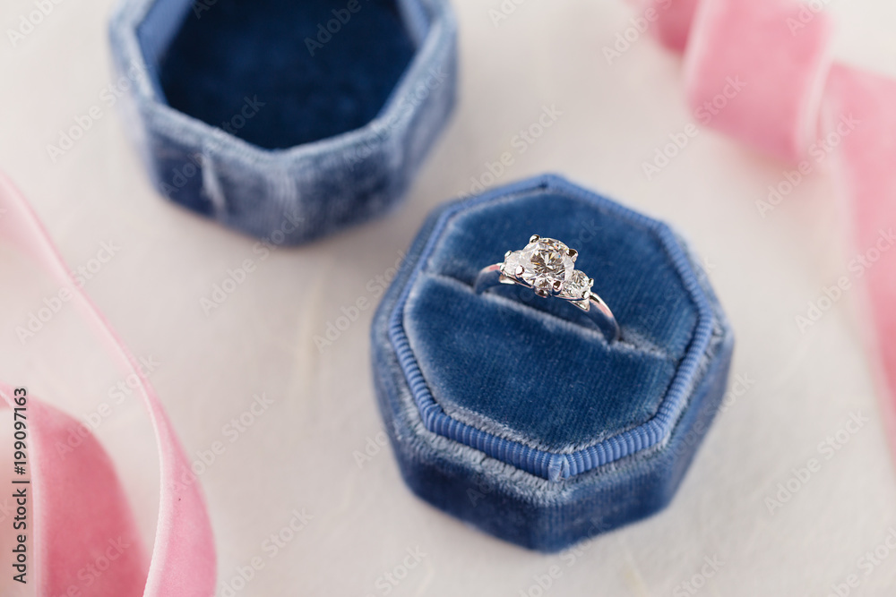 White golden wedding ring with diamonds in blue vintage velvet box White golden wedding ring with diamonds in blue vintage velvet box