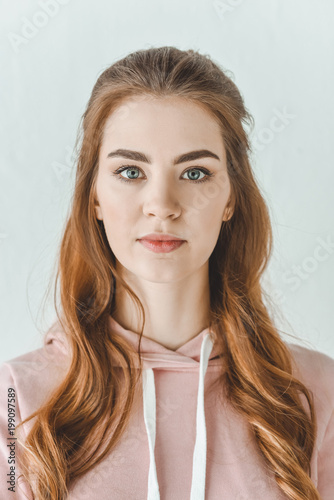 portrait of attractive young girl looking at camera, isolated on white