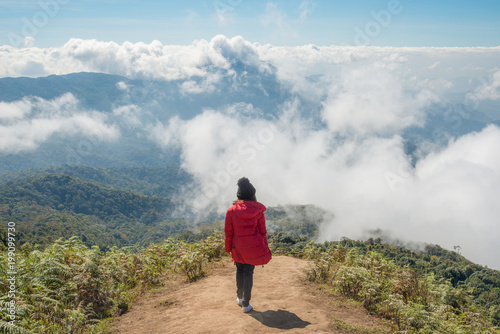 Women standing on the top of Kiw Mae Pan ridge in the winter season of Chiang Mai province of Thailand.