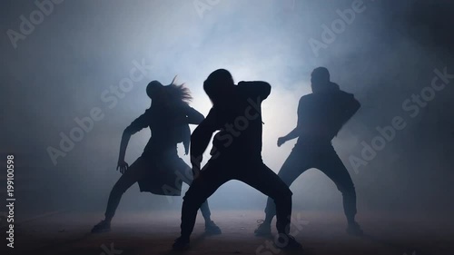 Group of young female dancers on the street at night.