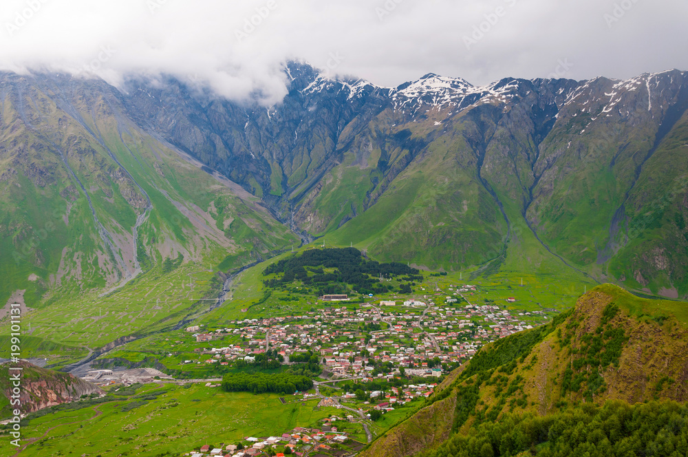 Fototapeta premium Panoramic beautiful view of the Stepantsminda village in the mountains. Georgia