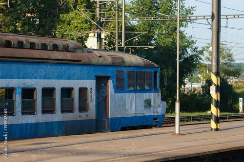 Old and very worn blue train stopped at some platform in central Europe