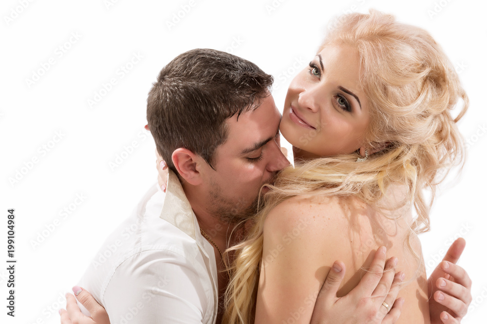Young beautiful couple in intimate proximity, kissing and hugging Young beautiful couple in intimate proximity, kissing and hugging