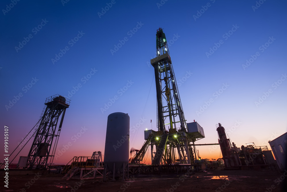 oilfield derrick at night