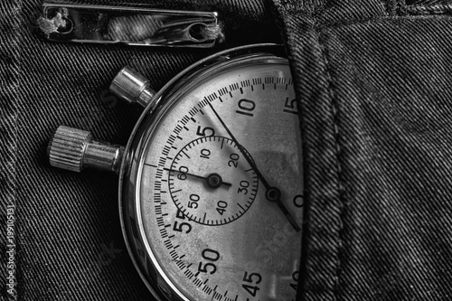 Vintage antiques Stopwatch, in black denim pocket with reflection plank, value measure time, old clock arrow minute, second accuracy timer record