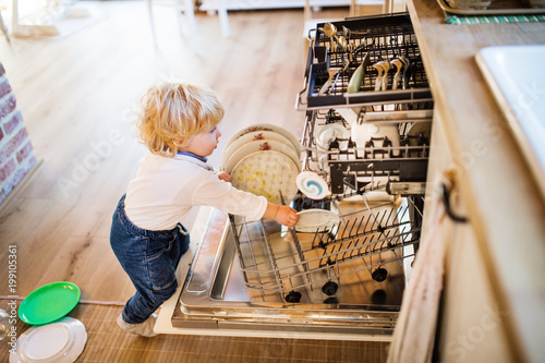 Canvas Print Toddler boy in dangerous situation at home. Child safety concept.