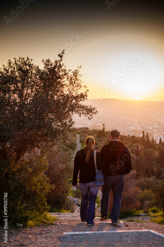 Couple walking downhill, Athens, Greece