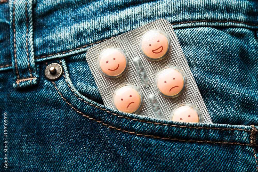 Pills in the jeans pocket. Concept of antidepressants