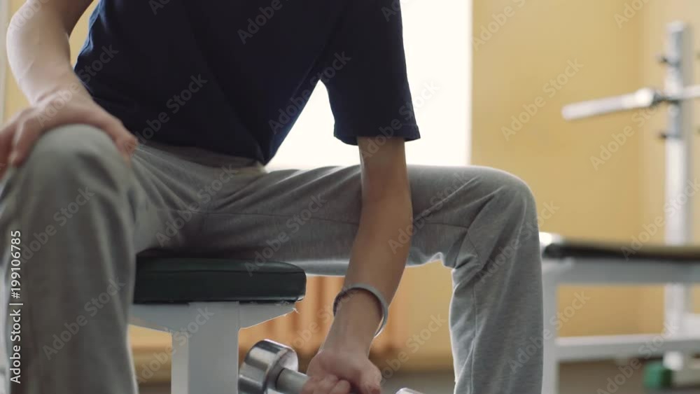 A 15-year-old boy with hearing impairment trains in the gym. The guy in the hearing aids is in the gym. A 15-year-old boy with hearing impairment trains in the gym. The guy in the hearing aids is in the gym.