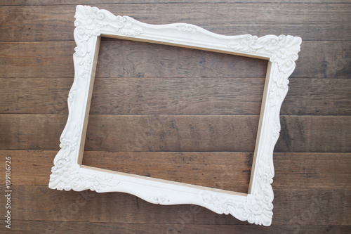 Vintage style white picture frame on wooden wall, Blank for copy space