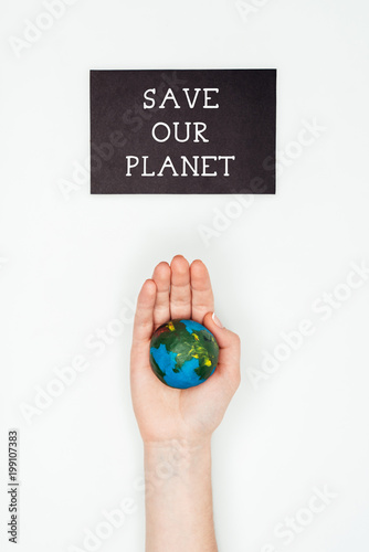 cropped image of woman holding earth model on hand under sign save our planet isolated on white, earth day concept