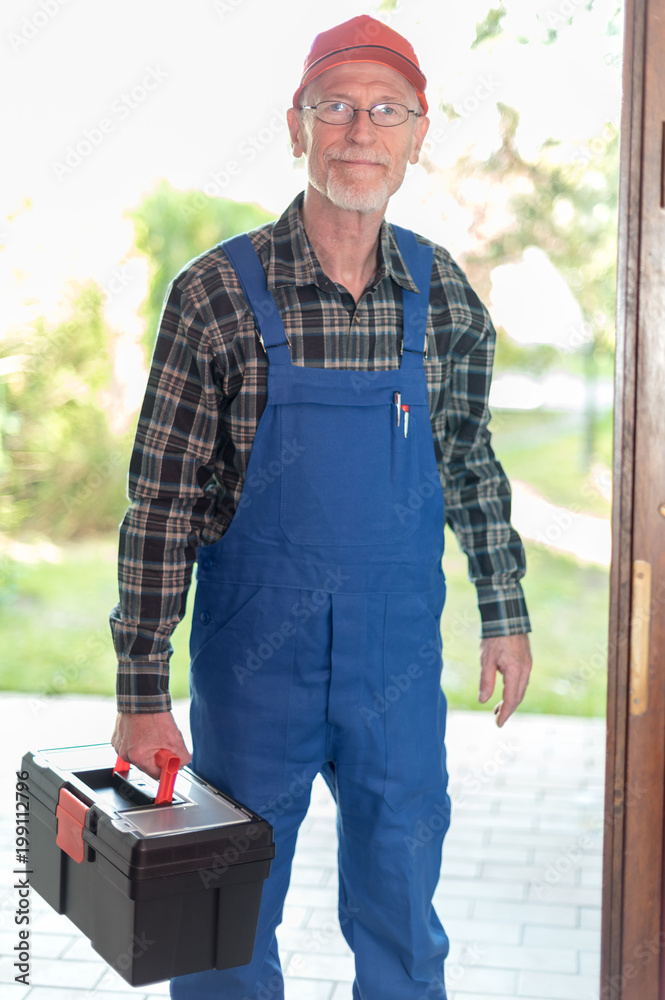 Portrait of a repairman holding his toolbox