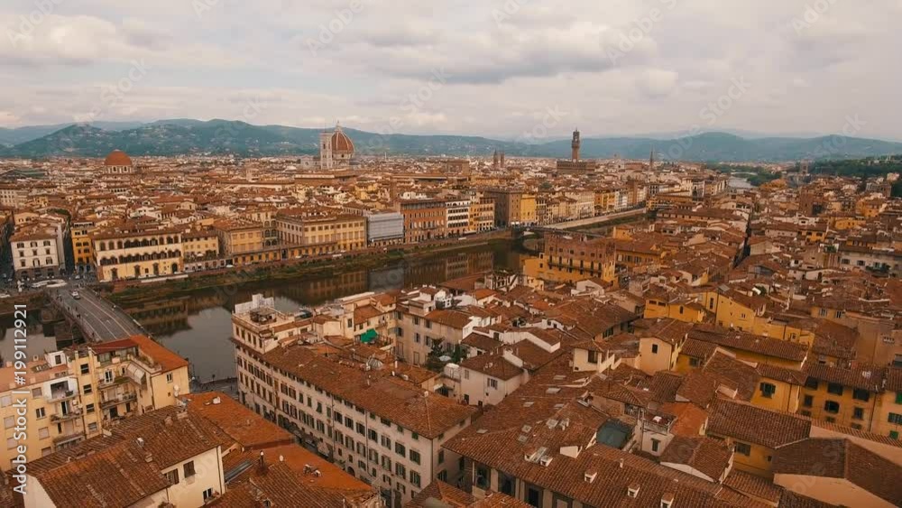 Drone aerial flying over Florence in the evening near the Arno River Drone aerial flying over Florence in the evening near the Arno River