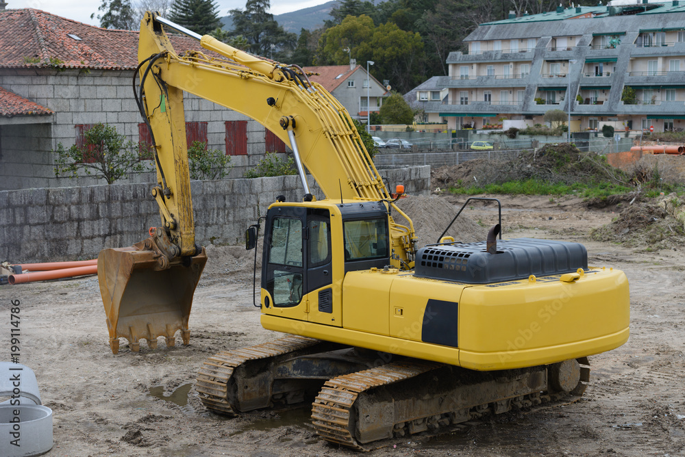 yellow excavator at construction site