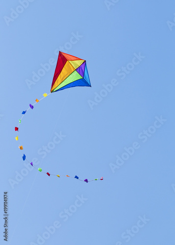 Colorful kite on the blue sky photo
