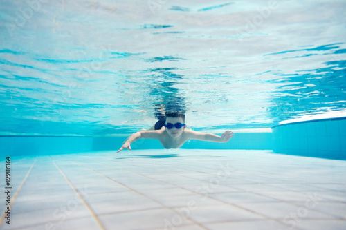 Young boy swimming underwater