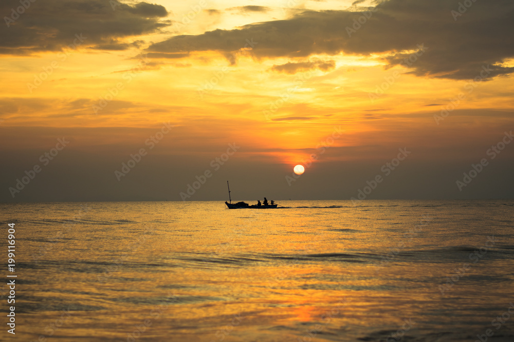 silhouette of fishing boat on sunset sea