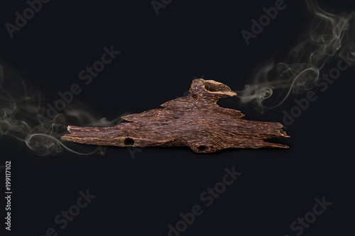 Close Up Macro Shot Of Sticks Of Agar Wood Or Agarwood Isolated On Black Background  With the smoke The Incense Chips Used For Arabic Oud Oils Or Bakhoor
