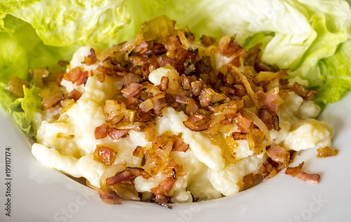 Potato dumplings with sheep cheese (slovak: bryndzove halusky) sprinkled with cooked bits of smoked pork fat photo