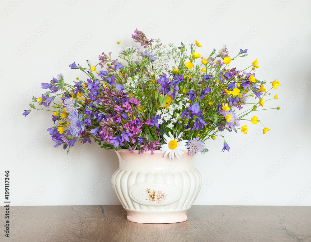 Mixed bouquet of wildflowers in an antique vase