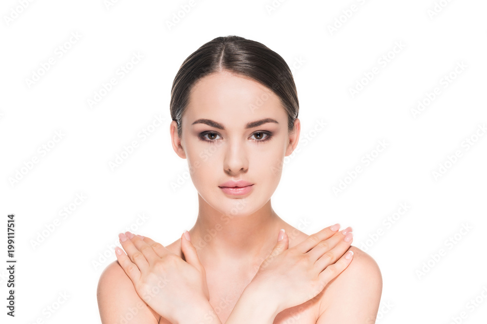 attractive young woman touching her shoulders and looking at camera isolated on white attractive young woman touching her shoulders and looking at camera isolated on white