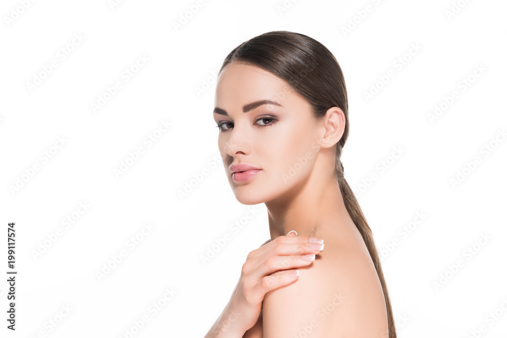 beautiful young woman touching her shoulder and looking at camera isolated on white beautiful young woman touching her shoulder and looking at camera isolated on white
