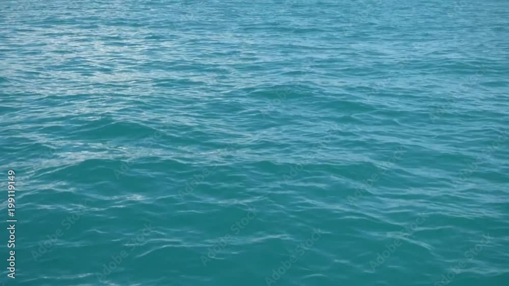 Sea water surface, view from moving boat. Small waves, sunny summer day. Natural background. Sea water surface, view from moving boat. Small waves, sunny summer day. Natural background.