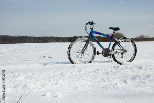 Colorful bike on a snowy field