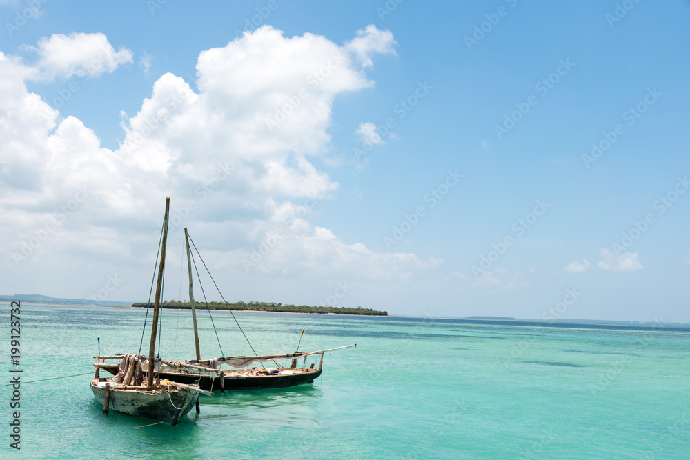 two authentic African wooden fishing boats,background ocean island 